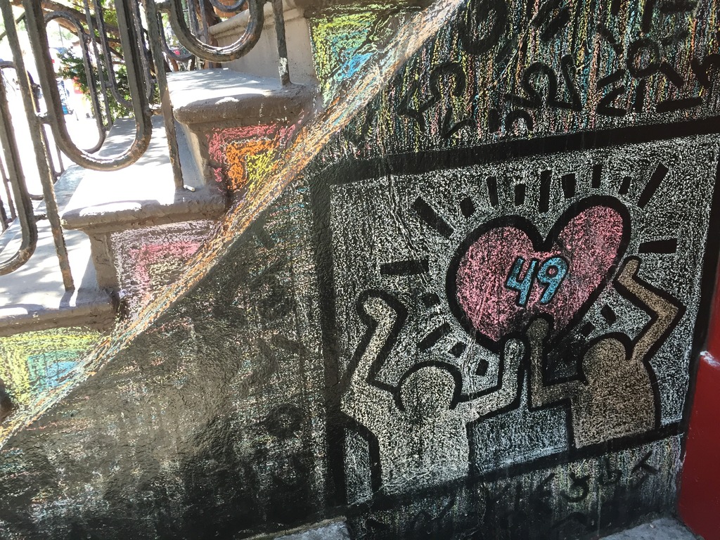 Street art: two chalk figures danger under a heart.